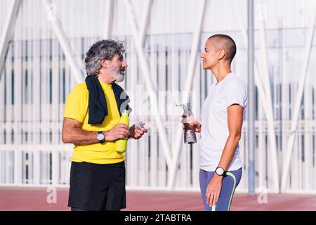 man talking with personal trainer before training Stock Photo