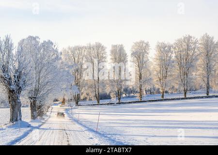 Car driving on a winter road in the countryside Stock Photo