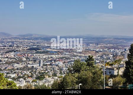 Haifa, Israel - October 22, 2023: Panorama of an industrial area and residential area against a blue sky with clouds. Stock Photo