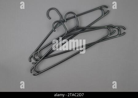many black Clothes Hanger on dark grey background. Black Friday Sale concept. Sale, save money, store, shopping concept, empty hanger Stock Photo