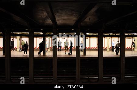 New York, USA - June 8, 2018: People on subway platform waiting for the train in New York. Stock Photo