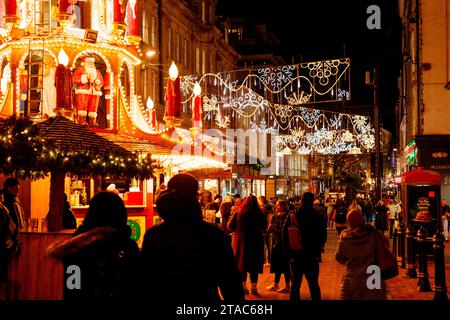 The view along New Street during Birmingham Frankfurt Christmas Market. The largest authentic German Christmas market outside of Germany or Austria. This year saw the iconic City Centre fountain 'Floozie in the Jacuzzi' bathed in red and green light joining other attractions welcoming the thousands of visitors from all over the world. Over 100 stalls lined the main streets in the City Centre and the market will be open until Christmas Eve.  Birmingham's Frankfurt Christmas Market offers a large range of traditional goods and gifts and a selection of tempting food and drink. Stock Photo