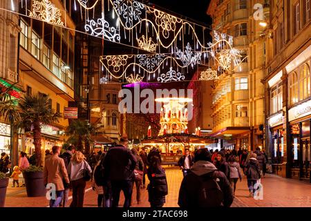 The view along New Street during Birmingham Frankfurt Christmas Market. The largest authentic German Christmas market outside of Germany or Austria. This year saw the iconic City Centre fountain 'Floozie in the Jacuzzi' bathed in red and green light joining other attractions welcoming the thousands of visitors from all over the world. Over 100 stalls lined the main streets in the City Centre and the market will be open until Christmas Eve.  Birmingham's Frankfurt Christmas Market offers a large range of traditional goods and gifts and a selection of tempting food and drink. Stock Photo