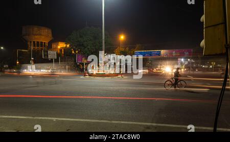 city street traffic long exposure shot with blurred light trails with at traffic control signal image is taken at sardar market ghantaGhar jodhpur raj Stock Photo