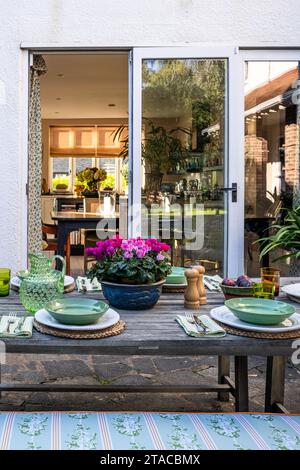 Set table on terraced exterior of 1930s Arts and Crafts style home. Hove, East Sussex, UK Stock Photo