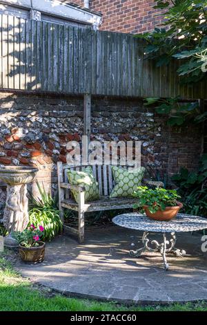 Bench and table on private terrace of 1930s Arts and Crafts style home. Hove, East Sussex, UK Stock Photo