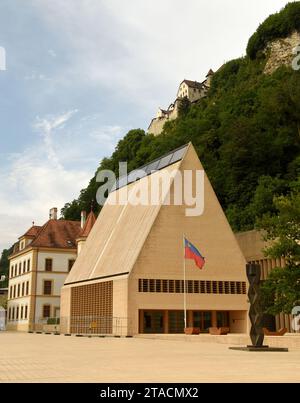 Vaduz, Liechtenstein - June 02, 2017: Liechtenstein parliament building and Gutenberg Castle at the background. Stock Photo