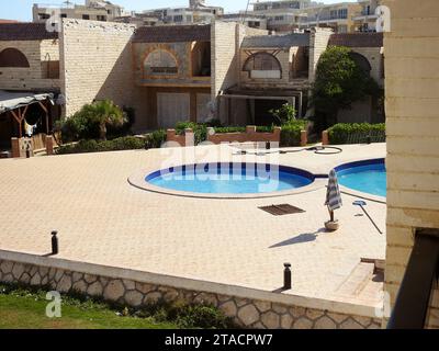 Alexandria, Egypt, September 10 2022: A swimming pool, swimming bath, wading paddling pool, a structure designed to hold water to enable swimming or o Stock Photo