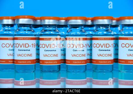 Ampoules with Covid-19 vaccine on a laboratory glass table. Medicine and corona virus infection Concept. Stock Photo