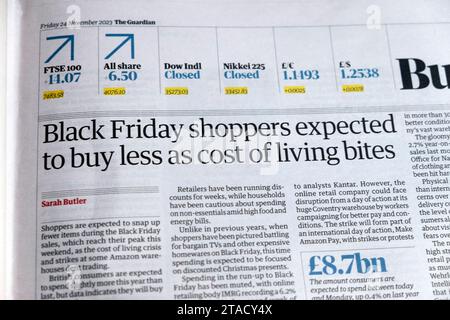 'Black Friday shoppers expected to buy less as cost of living bites' Guardian newspaper headline retail business article 24 November 2023 London UK Stock Photo