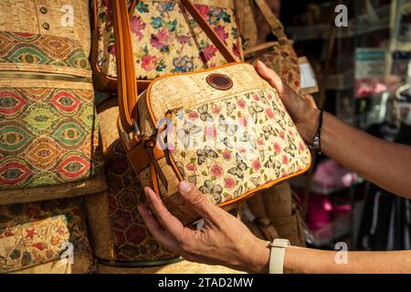 Woman buying a vintage cork bag, Coimbra Stock Photo