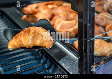 Croissants stored for sale and consumption. Popular French pastries Stock Photo