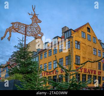 Christmas decoration of a reindeer jumping over the Nyhavn 17 restaurant in Copenhagen, November 25, 2023 Stock Photo