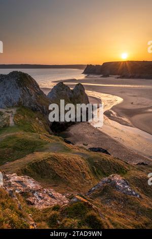 Golden sunset over Three Cliffs Bay on the Gower Peninsula, South Wales, UK. Spring (March) 2022. Stock Photo