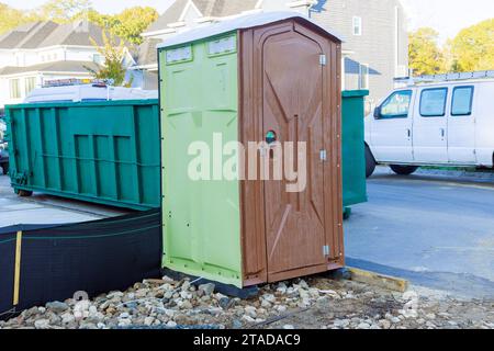 On construction site during building of new home, there is portable temporary toilet Stock Photo