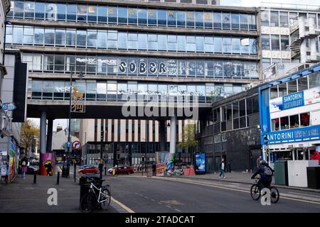 Street scene with the partially disused Ringway Centre which crosses above Hurst Street on 3rd November 2023 in Birmingham, United Kingdom. Ringway Centre is a Grade B locally listed building located on Smallbrook Queensway in the city centre. The six-storey, 230 metres long building was designed by architect James Roberts as part of the Inner Ring Road scheme in the 1950s and is notable for its gentle sweeping curved frontal elevation. In July 2016, the building was refused listed status by Historic England which enables redevelopment to take place. Stock Photo