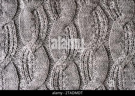 Gray woolen knitted sweater fabric, texture, background. Stock Photo
