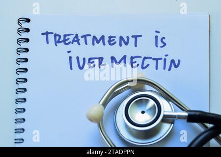 Concept of Treatment is Ivermection write on book with stethoscope isolated on white background. Stock Photo