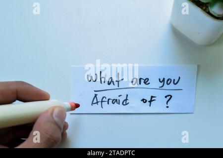 Concept of What are you Afraid of? write on sticky notes isolated on white background. Stock Photo
