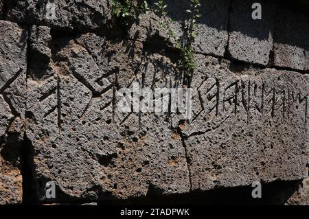 Over the entrance to an Etruscan chamber tomb, an inscription in Old Italic, the Etruscan language and script, with the name of the family buried there.  This tomb is in the Crocifisso del Tufo, the northern necropolis of the ancient Etruscan city of Velzna or Velusna at Orvieto, Umbria, Italy.  Etruscan citizens were interred here from the 8th century to the 3rd century BC.  The Crocifisso del Tufo was discovered and excavated more than 2,000 years later, in the 19th century. Stock Photo