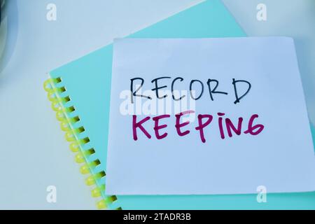 Concept of Record Keeping write on sticky notes isolated on white background. Stock Photo