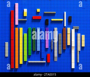 Colorful lego bricks on bright royal blue board Stock Photo