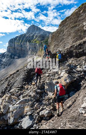 France, Haute-Savoie (74), Massif du Chablais, Montagnes du Giffre, Sixt-Fer-à-Cheval, Sixt-Fer-à-Cheval nature reserve, hikers walking towards the Col des Chambres, Pointe de Bellegarde (2514m) in the background Stock Photo