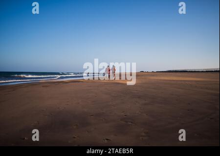 Couple walks on the beach in Lanzarote, Canary Islands, Spain Stock Photo