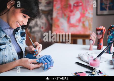 Young artist painting in art class at school studio. Creative people doing craft work Stock Photo