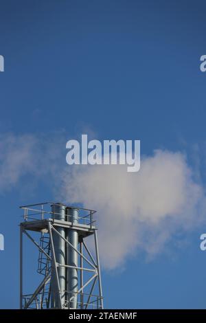 environmental Pollution. Industrial chimneys in exhaust emissions. A metal pipe with white smoke coming from it...Ecological concept. Stock Photo