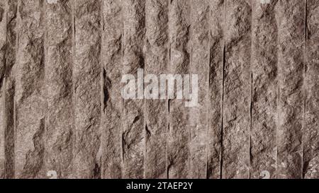 Brown stone wall. Fragment of a stone wall with vertical, relief stripes. Stock Photo