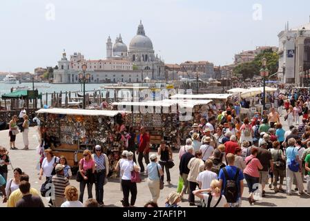 VENICE, ITALY - JUNE 04, 2009: Tourists in the crowded St Mark's Square with Basilica Santa Maria della Salute on the backgrounds Stock Photo