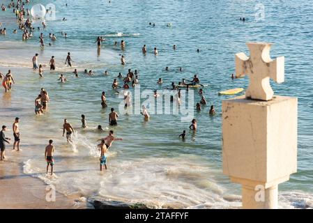 Salvador, Bahia, Brazil - October 21, 2023: Tourists have fun on the beach of Porto da Barra postcard of the city of Salvador, Bahia. Stock Photo