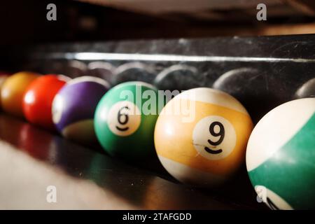 Selective focus at pool billiards ball on the cabinet side of pool billiard table. Stock Photo