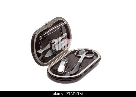 Set of steel manicure instruments and tools in black leather case isolated on white background. Stock Photo