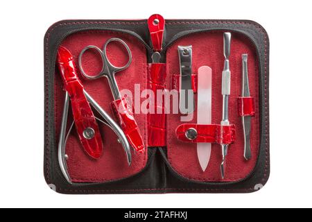 Set of steel manicure instruments and tools in red leather case isolated on white background. Stock Photo
