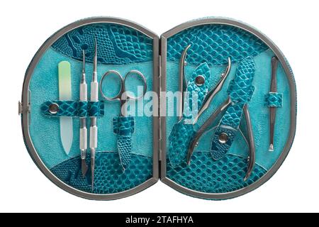 Set of steel manicure instruments and tools in blue leather case isolated on white background. Stock Photo