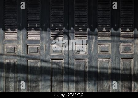 Time-Worn Elegance, Antique Black Wooden Window Shutters. Stock Photo