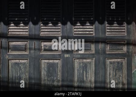 Time-Worn Elegance, Antique Black Wooden Window Shutters. Stock Photo