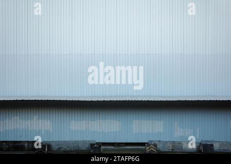 Textured Corrugated Metal Siding on Industrial Building Facade of temporary construction site. Stock Photo