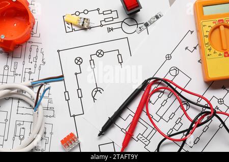 Digital multimeter and other electrician's equipment on wiring diagrams, flat lay Stock Photo
