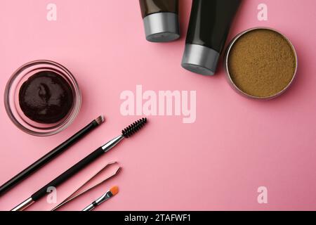 Flat lay composition with eyebrow henna and tools on pink background. Space for text Stock Photo