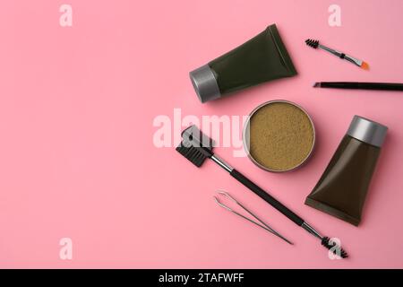 Flat lay composition with eyebrow henna and tools on pink background. Space for text Stock Photo