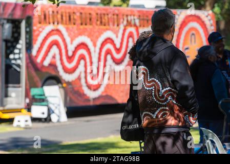 First Nations indigenous Aboriginal man wearing a Kinchela art design jacket at the Sorry Day event in Sydney during National Reconciliation Week Stock Photo