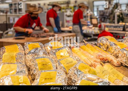 Ready-made BBQ items await while employees chop brisket and prepare sandwiches at Buc-ees mega travel center along I-95 in Daytona Beach, Florida. Stock Photo