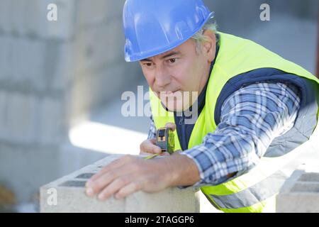 a man working on cement blocks Stock Photo