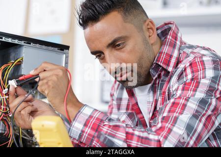 electrical engineer checking a pc Stock Photo