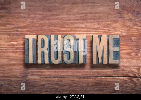 trust me phrase combined on vintage varnished wooden surface Stock Photo