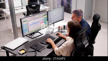 Medical Coder Working on Multiple Spreadsheets with Computer Stock Photo
