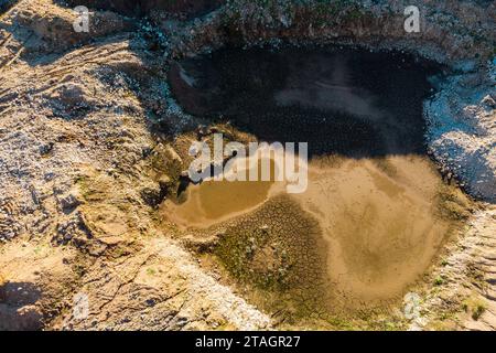 Aerial view of a pit dug in a quarry for the extraction of crushed stone Stock Photo